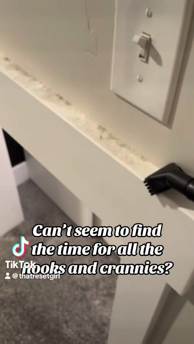 Dusting wall trim during a recurring house cleaning visit
